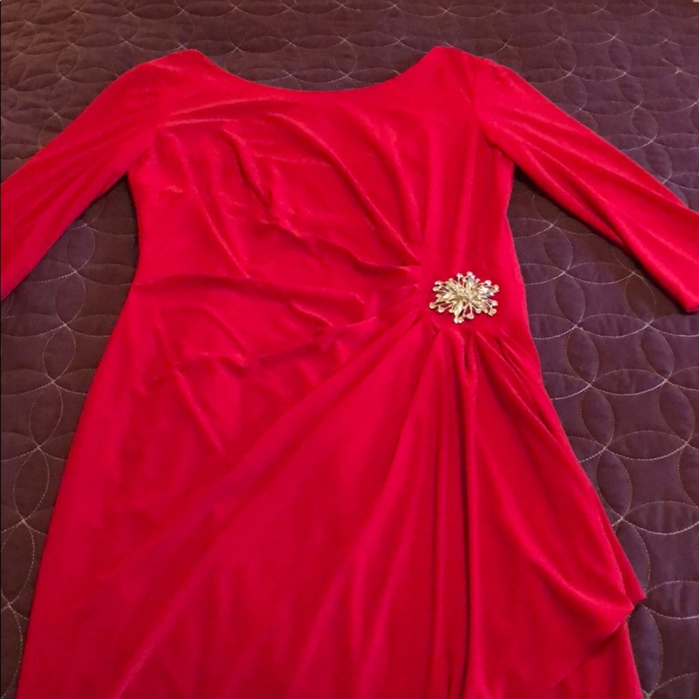 Red cocktail length evening dress with brooch